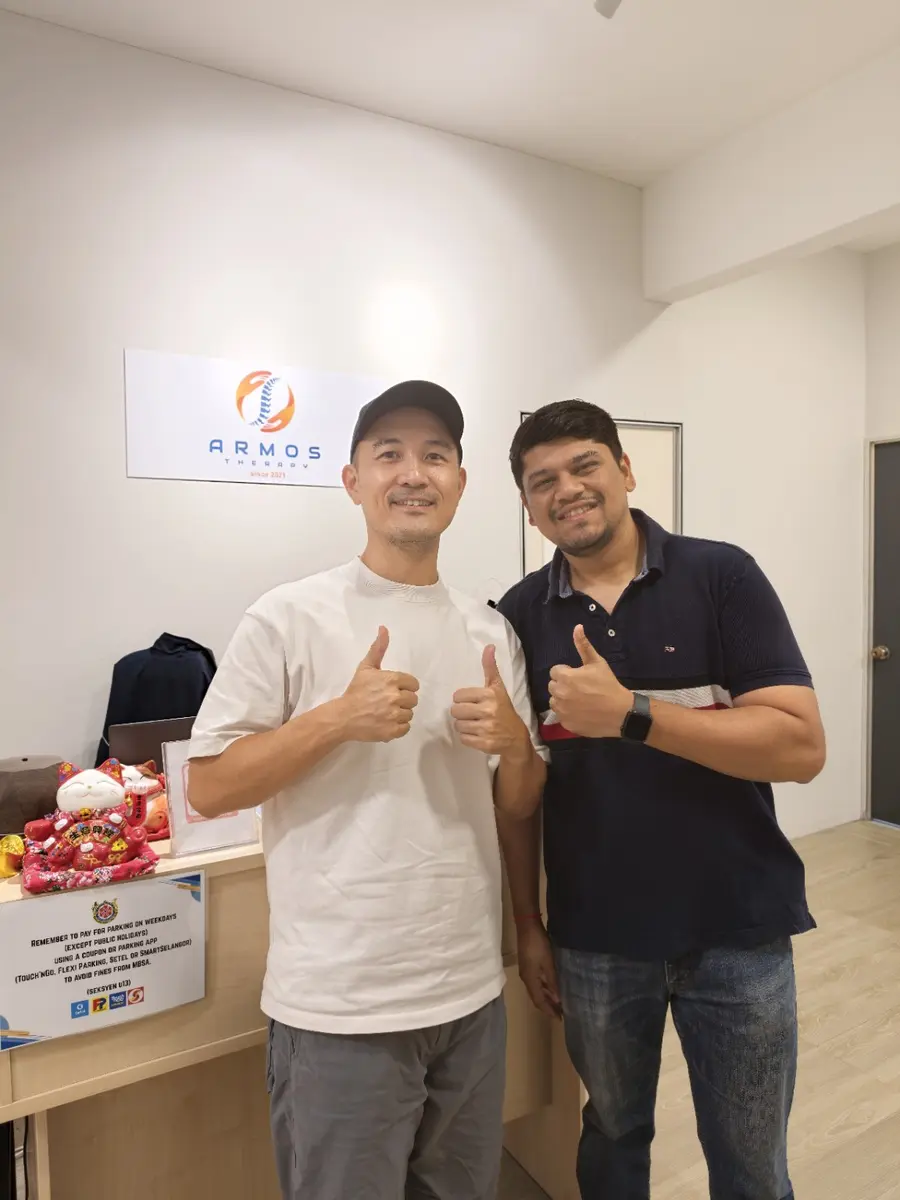 Winston and an Armos patient giving a thumbs up