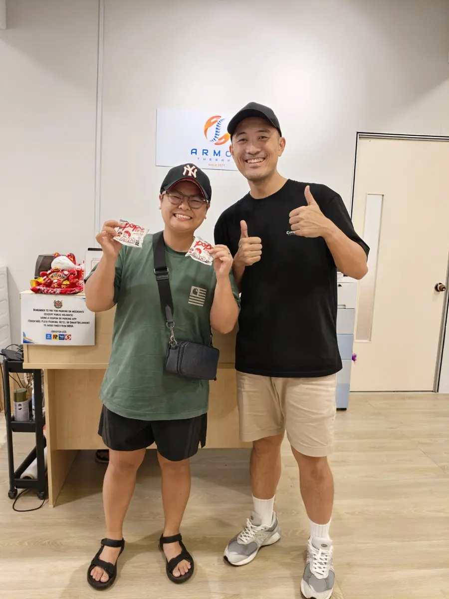 Winston with a patient at Armos Therapy